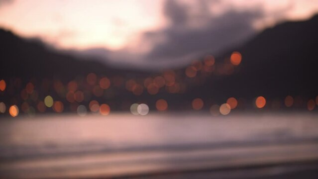 Out of focus video for background or copy space of seaside and city at sunset