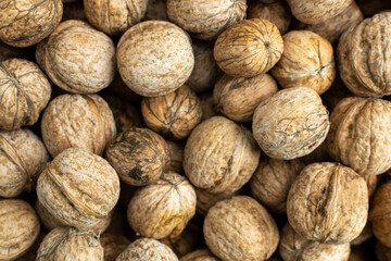 Background of fresh walnuts, vegetable protein for vegetarianism and raw food. The concept is healthy eating.