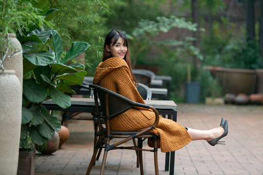 Woman Sitting On A Bench In The Park