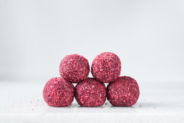 Raspberry coconut and chocolate truffles, homemade chocolate bonbons on white background