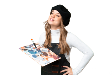 Young artist girl holding a palette over isolated chroma key background posing with arms at hip and smiling