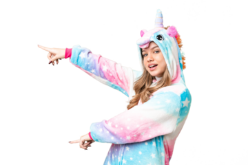 Young girl with unicorn pajamas over isolated chroma key background pointing finger to the side and presenting a product