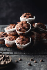 Close up of chocolate chip zucchini muffins on black background.
