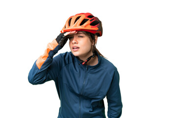 Young cyclist girl over isolated chroma key background looking far away with hand to look something