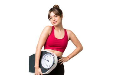 Young girl over isolated chroma key background with arms at hip and holding weighing machine