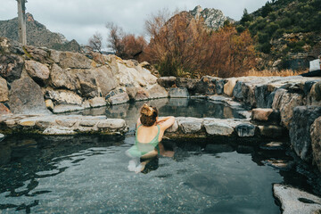 Portrait of woman in natural hot springs relaxing - obrazy, fototapety, plakaty