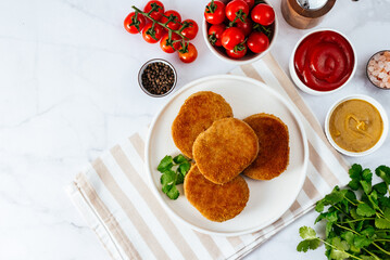 deep fried chicken cutlets on a plate with sauce