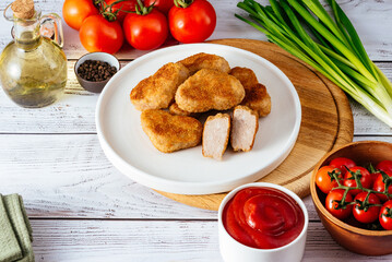 chicken nuggets in the shape of a heart on a plate with sauce