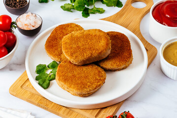 deep fried chicken cutlets on a plate with sauce