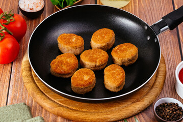 fried chicken nuggets in a frying pan on the table, sauce and ve