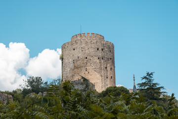 Rumeli Fortress with cloudy blue sky, historical structures in Istanbul, aged castle view with trees, Rumelihisarı in Turkish, Constantinople fortress, landscape from Istanbul, popular destination