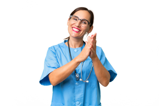 Middle-aged nurse woman over isolated background applauding after presentation in a conference