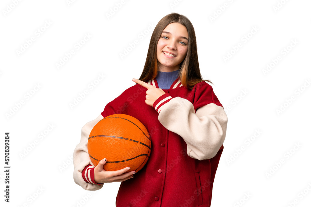 Sticker Teenager girl playing basketball over isolated chroma key background pointing to the side to present a product