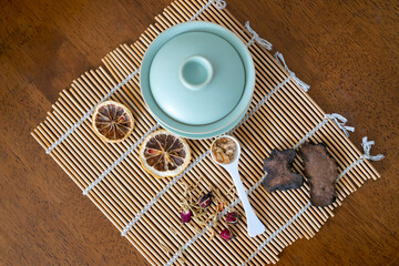 Close-up teacups and various dried teas