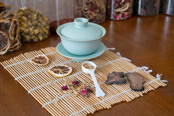 Close-up teacups and various dried teas