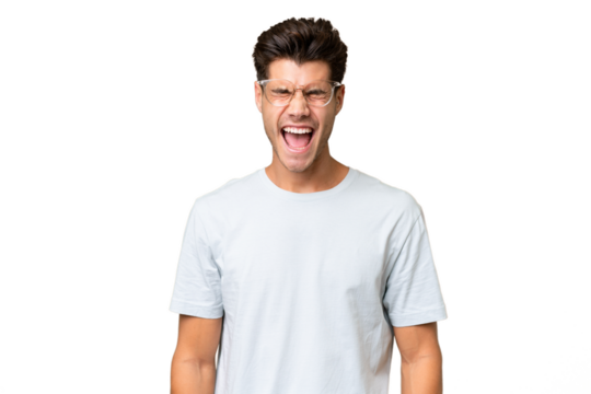 Young caucasian handsome man over isolated background shouting to the front with mouth wide open