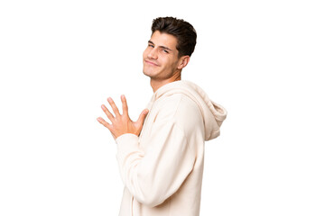 Young caucasian handsome man over isolated background scheming something