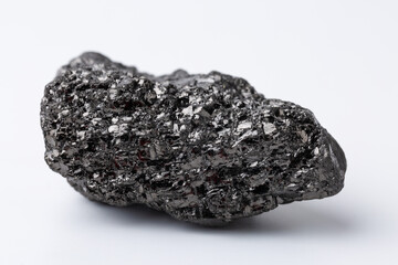Natural black fossil coal on a white isolated background.