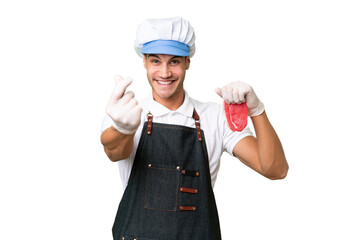 Butcher caucasian man wearing an apron and serving fresh cut meat over isolated background making money gesture