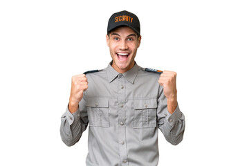 Young security man over isolated background celebrating a victory in winner position