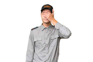 Young security man over isolated background covering eyes by hands. Do not want to see something