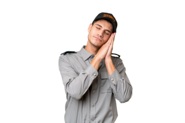 Young security man over isolated background making sleep gesture in dorable expression
