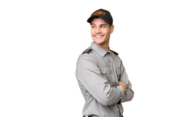 Young security man over isolated background with arms crossed and happy