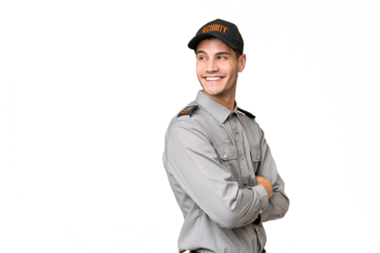 Young security man over isolated background with arms crossed and happy