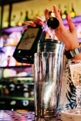 man bartender making cocktail in bar