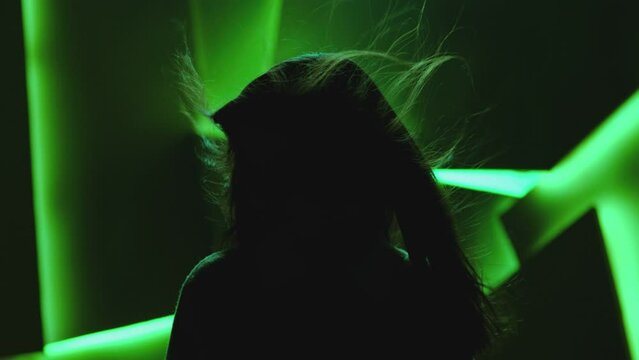 Close up portrait of pretty brunette female model . Beautiful attractive face of young woman . Hair flowing or blowing in wind . Face Changes Depending on the Lighting . Shadow and light movement . 