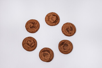Three Chocolate Brownie Cookies on Linen Napkin Tasty Snack or Dessert Blue Background Copy Space Top View