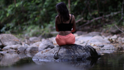 Woman relaxing meditating pose at beautiful Thai landscape in lotus position.Recreation on Koh Samui