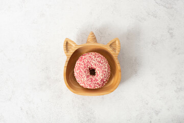 Fototapeta na wymiar pink donut in unicorn plate, party
