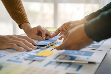 UI developer and ui designer brainstorming about mobile app interface wireframe design with...