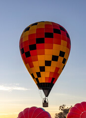 hot air balloon in flight, taking off at sunrise