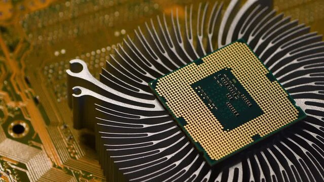 detail of a modern computer processor on the cooling fins of an aluminum computer heat sink. technology, electronics and engineering backgrounds