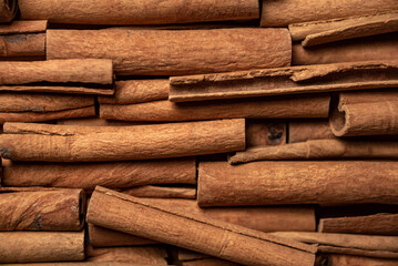 Many cinnamon rolls stacked in an even order, top view