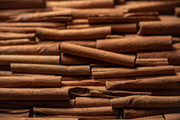 Many cinnamon rolls stacked in an even order, top view