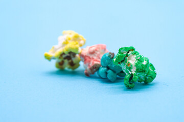 colored popcorn with sugar on blue background