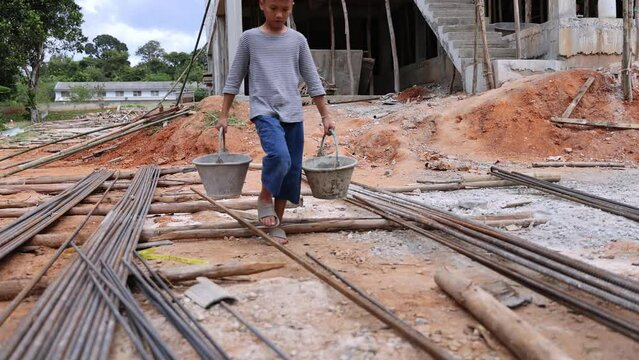 Children are forced to work in construction. anti child labor Abuse, oppression or coercion, forced child labor Human trafficking. 4K slow motion.