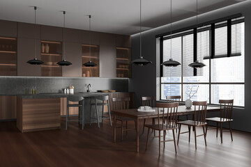 Dark kitchen interior with bar countertop and dining area near panoramic window