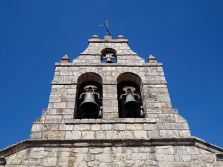 Stone bell tower with three bells of the church Nuestra Señora de la Natividad (Our Lady of the...