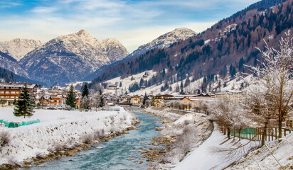 River surrounded by snow and forest on a sunny winter day