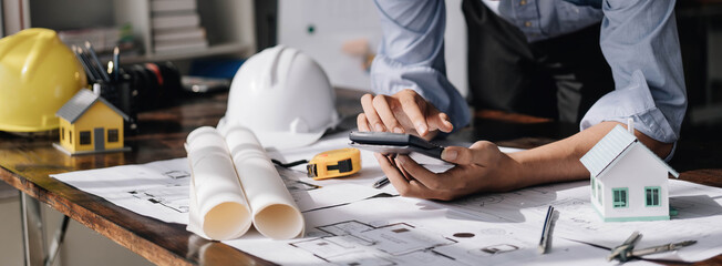 Image of engineer drawing a blue print design building or house, An engineer workplace with...