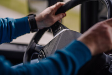 Driver of semi-truck sitting and drining his vehicle
