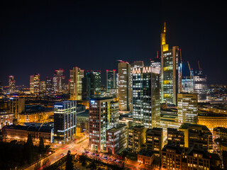 Fototapeta na wymiar aerial view of the illuminated skyscrapers in the city at night, frankfurt main, germany