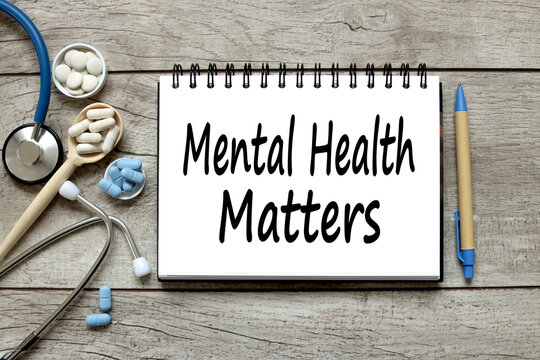 Mental Health Matters Wooden Background With Notepad. Text On Paper. Medicine Concept.