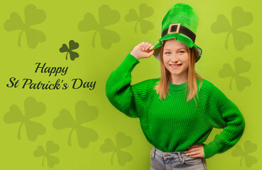 Happy smiling irish girl in green leprechaun hat and green sweater holding hand on hip isolated on...