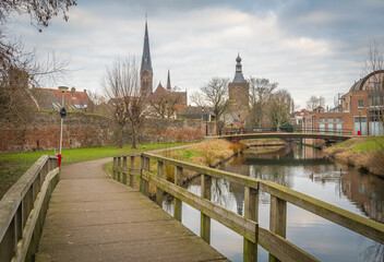Dutch city of Culemborg, scenery with wooden bridge, old city wall, church and the gate tower