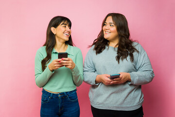 Excited best friends texting using social media